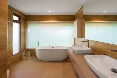 a bathroom with a large tub and a sink at Blue Moon by G Estate Phuket in Ban Saiyuan (1)