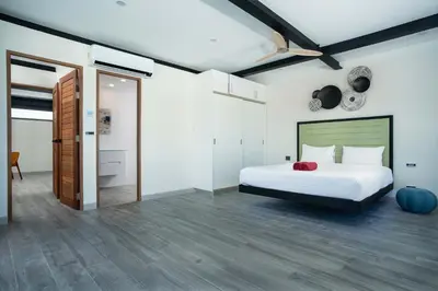a bedroom with a bed and a ceiling fan at LUXURY 4BR Oxygen Pool Villa Near Nai Harn Beach - Sunset Garden 7 in Rawai Beach