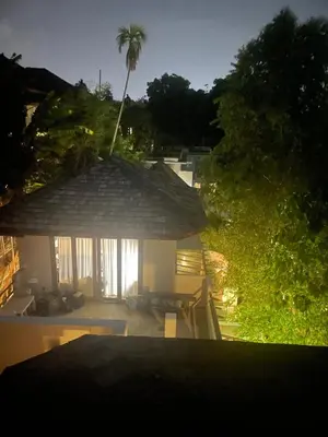 a view of a house with a large umbrella at The Hip House Villa Phuket in Ban Bang Khu