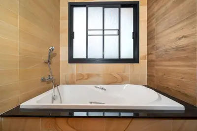 a bath tub in a bathroom with a window at VIP Pool Villa 3E1 230m Rawai Beach in Rawai Beach