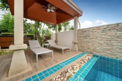 a patio with two chairs and a swimming pool at VIP Pool Villa 3E1 230m Rawai Beach in Rawai Beach