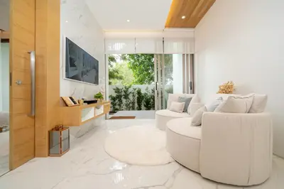 a white living room with a white couch at Andaman Villa 15 minutes from Bangtao Beach in Phuket Town