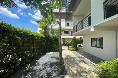 an external view of a house with a fence at Alisse Stay Phuket Layan in Phuket Town