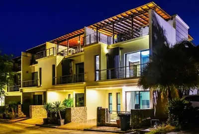 a large white building with balconies at night at Kamala townhome with sea view terrace & pool in Kamala Beach