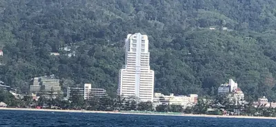 a tall white building in front of a city at Patong tower 2bedroom 2 bathrooms, corner view in Patong Beach