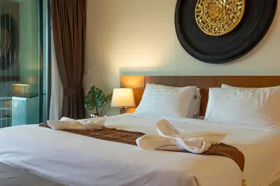a bedroom with a large bed with white sheets at C260 Beach And Town, Modern Big Apartment in Phuket Town