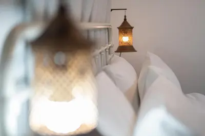 a living room with a white couch and a lamp at Baan Old Town Boutique Stay, Phuket Town in Phuket Town