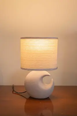 a white lamp sitting on top of a table at Maiiam Guesthouse Patong in Patong Beach