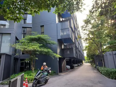 a scooter parked on a street next to a building at The Deck Condo Patong 5Fl Pool View in Patong Beach