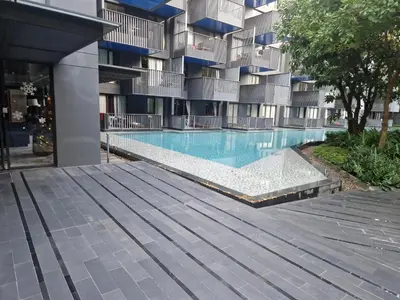 a swimming pool in front of a building at The Deck Condo Patong 5Fl Pool View in Patong Beach