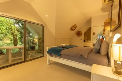 a bedroom with a large bed and a large window at Brand new, designer furnishing, hot tub, gym, pool V98 in Rawai Beach