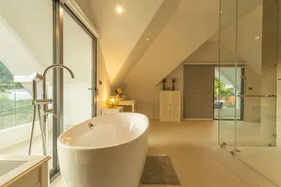 a bathroom with a tub and a glass shower at Brand new, designer furnishing, hot tub, gym, pool V98 in Rawai Beach