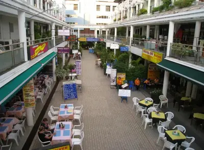 an empty street with tables and chairs in a building at Sea view apartment with jacuzzi at Patong Tower in Patong Beach