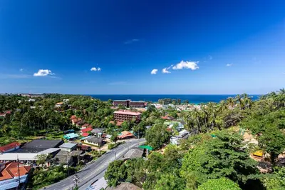 an aerial view of a town and the ocean at Spacious mountain view studio at Sea Sky 206 in Karon Beach