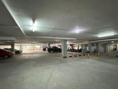 an empty parking garage with cars parked in it at Peaceful Rawai studio with washer by Lofty in Rawai Beach