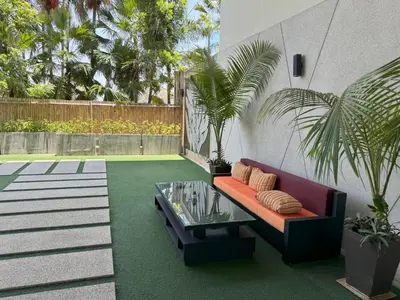 a patio with a couch and a glass table at Peaceful Rawai studio with washer by Lofty in Rawai Beach