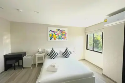 a white room with a bed and a desk at B4 БАССЕЙН ВаТСАП669З582I976 in Nai Yang Beach