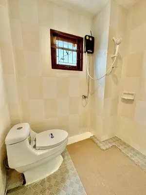 a bathroom with a toilet and a shower in it at Amazing 4BR pool villa near beach Bangtao in Ban Thalat Choeng Thale