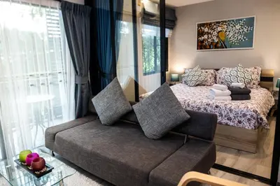 a bedroom with a bed with a couch in front of it at G14 SuperKingSizeBed 1этаж тихая сторона in Nai Yang Beach