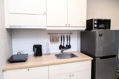 a kitchen with a sink and a refrigerator at G14 SuperKingSizeBed 1этаж тихая сторона in Nai Yang Beach