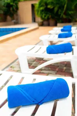 a group of white chairs with blue cushions on them at Lovely,Private 7 bedroom pool villa Kamala in Kamala Beach