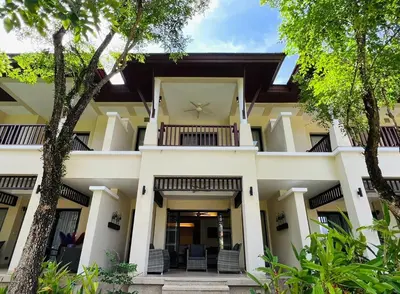 an exterior view of a house with trees at Laguna Village by RESAVA in Layan Beach