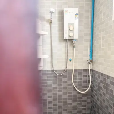 a shower in a bathroom with two shower heads at Happy House in Phi Phi Don