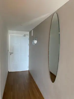 a hallway with a mirror on a wall with a door at Sea View One Bedroom Condo in Kata Beach in Kata Beach
