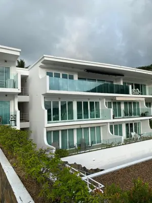 a white building with a lot of windows at Sea View One Bedroom Condo in Kata Beach in Kata Beach