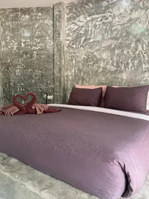 a large purple bed with two hearts on it at Green Tree Cottage 2 in Klong Muang Beach