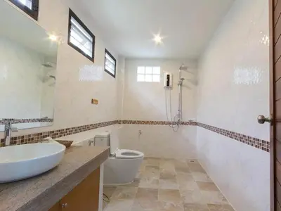a bathroom with a sink and a toilet at Moonlight Cottage in Ban Pa Khlok