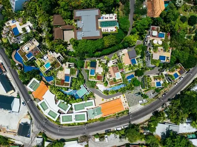 an overhead view of a city with houses and a road at Luxury Penthouse Apartment 8C at Kata Gardens in Kata Beach