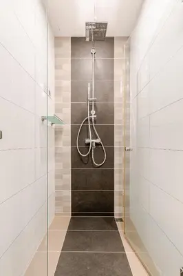 a bathroom with a shower with a glass door at The Proud Rawai Studio in Phuket Town