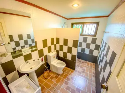 a bathroom with a toilet and a sink at Garden & private pool house in Surin Beach