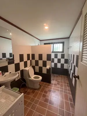 a bathroom with a toilet and a sink at Garden & private pool house in Surin Beach