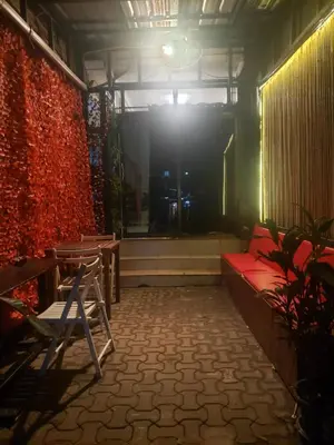 a room with a bed and a table and a light at Lucky Dorm in Phi Phi Don