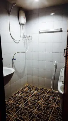 a bathroom with a shower and a sink and a toilet at Lucky Dorm in Phi Phi Don