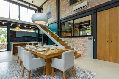 a dining room with a table and chairs and a staircase at New Ultra Modern Designer Furniture Gym #v62 in Chalong