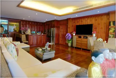 a living room with wood paneling and a flat screen tv at Villa REGTUK in Patong Beach