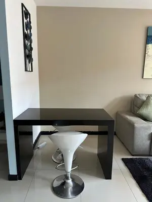 a black desk in a living room with a couch at Nai Harn Beach Condo (C2) in Rawai Beach