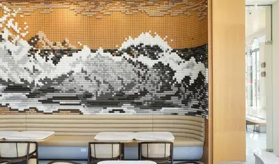a restaurant with a wall with a mural of mountains at Arco Phuket Town in Phuket Town