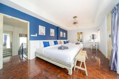 a bedroom with a large white bed and blue walls at Bangla Patong Pool Villas with 4 Villas different designs choose fro, photo before Book in Patong Beach