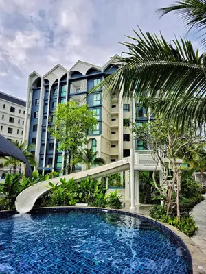 a swimming pool in front of a large building at The Title Halo 1 Jupiter in Nai Yang Beach