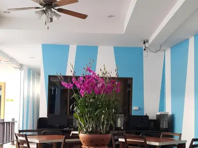 a room with a ceiling fan and a potted plant at MT Hotel Patong in Patong Beach