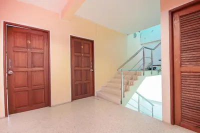 a room with two doors and a staircase with a glass railing at OYO 1148 Aonang Andaman Resort in Ao Nang Beach