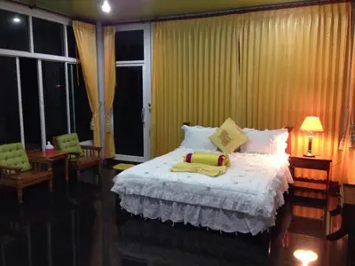 a bedroom with a white bed with two towels on it at Sairougn Seaview Hotel in Ban Ko Kwang