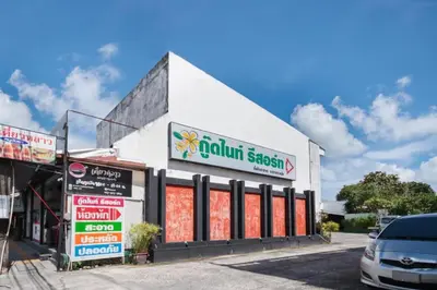 a building with a sign on the side of it at OYO 1172 Goodnight Resort in Phuket Town