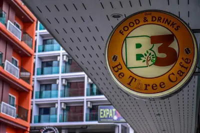 a sign for a food and drinks bar in front of a building at Ocean and Ole Patong in Patong Beach
