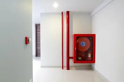 a white wall with a red box in a room at Elegancy Sansabai Hotel in Patong Beach