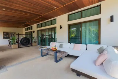 a living room with a white couch and a table at Villa Oxavia in Rawai Beach